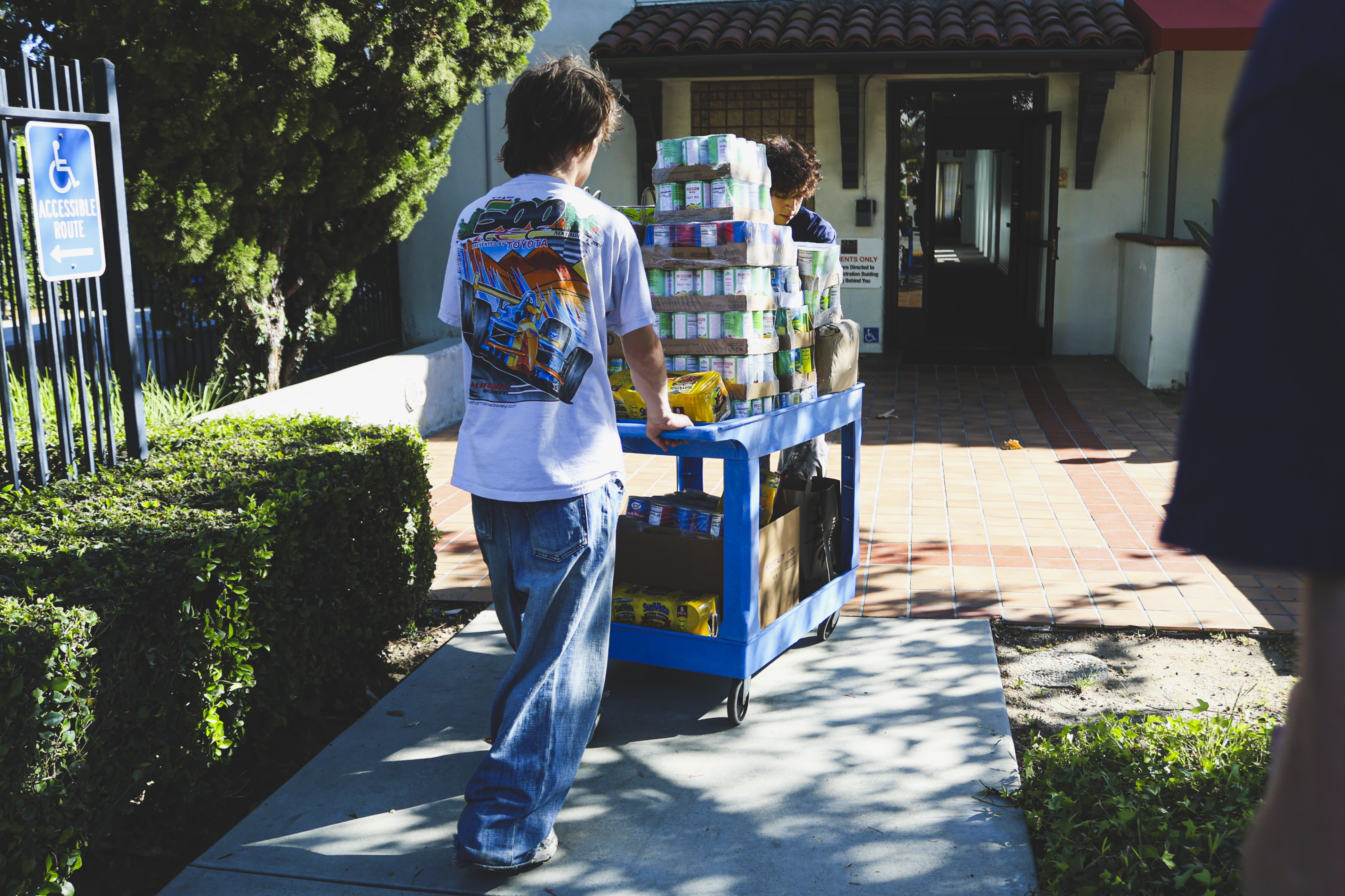 Volunteers pushing a cart loaded with donations